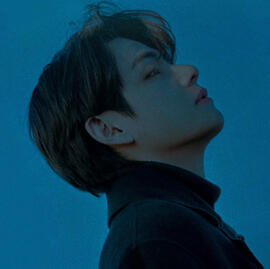 a blue-tinted picture of taehyung gazing up at jungkook’s picture above him. the image’s border is a circle.